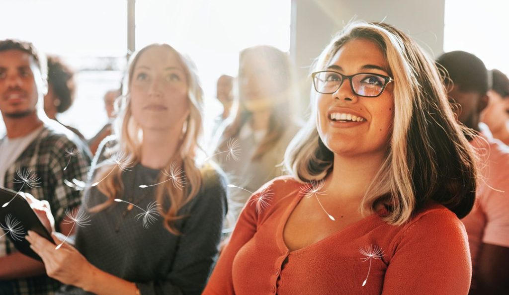 Group of diverse co-workers in a training class listening to an instructor.